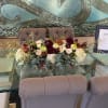 Low floral centerpiece with roses and mums on a table