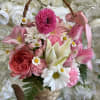Pink and white flower basket with a ribbon handle