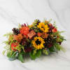 Autumn bouquet with sunflowers, orange roses, and pinecones