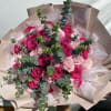 Bouquet of pink and hot pink roses with eucalyptus in blush wrapping