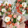 A bright and refreshing hand-wrapped bouquet designed with a seasonal mix of