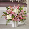 Pink and white floral arrangement in a white vase