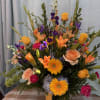 A large, bright arrangement of blooms in vibrant summer colors. Perfect for