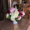 Pink and white floral arrangement in a white vase
