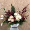Live pine tree, orchids, lt. pink roses, tulips, red tiger lily, lisianthus