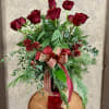 These festive roses include christmas gteens and ribbon that are perfect for