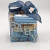 Clear gift box with blue ribbon and chocolate pieces labeled BABY