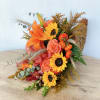 Orange and yellow bouquet with roses, sunflowers, and lilies