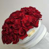 50 beautiful red roses nicely arranged in a white cement vase. 