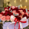 A lavish heart-shaped box filled with premium red and blush pink roses