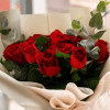 Twelve velvety red roses with lush eucalyptus, wrapped in elegant cream paper