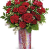 Red roses and carnations arranged in a mosaic vase