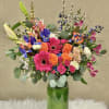 Colorful mixed bouquet in a tall glass vase