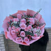 Large bouquet of pink roses and carnations wrapped in pink paper