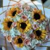 Bouquet of sunflowers, pink roses, and baby's breath in white wrap