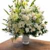 This elegant white sympathy flower arrangement is designed to express peace, love