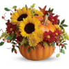 Sunflowers and autumn flowers arranged in a pumpkin-shaped container