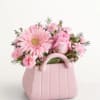 A cheerful cluster of soft pink gerbera daisies, roses, and carnations arranged