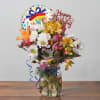 Birthday bouquet in a glass jar with a foil balloon and glitter topper