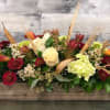 Rustic yet elegant, this unique centerpiece has loads of bright fall colors
