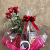 Three roses red or pink in a wrap with Russel Stover strawberry