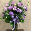 Lavender Roses and Lavender Lisianthus in a tall vase with a lavender