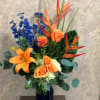 Type of Flowers: Orange Birds of Paradise, Blue Delphinium, Orange Roses, Orange