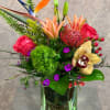 Send a Touch of Paradise to someone special, this arrangement includes orange