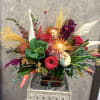 Type of Flowers: This modern centerpiece includes Cabbage, Snapdragon, Hot Orange Roses