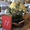 This classical center piece is designed with white hydrangaes and babies breath