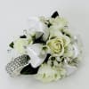 White rose corsage with ribbon and rhinestone accents