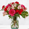 Pink and red mixed bouquet in a clear glass vase