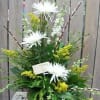 White spider mums in a mixed green floral arrangement