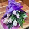 Pale pink tulips take center stage in this Totally Tulips bouquet, a