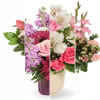 Mixed bouquet of pink, purple, and white flowers in a vase