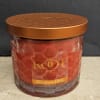 A richly hued strawberry-scented candle that makes a cozy gift for birthdays