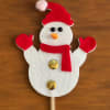 Snowman decoration with red hat, scarf, and mittens on a stick