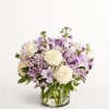 Lavender and white flower arrangement in a clear glass vase
