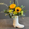Sunflower arrangement in a white boot-shaped vase
