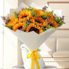 Bouquet of sunflowers wrapped in white paper with a yellow ribbon
