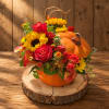 Pumpkin-shaped floral arrangement with red roses and yellow sunflowers