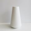 Tall white ceramic vase on a plain background