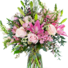 Tall pink and white bouquet with lilies and roses in a clear glass vase