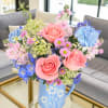 Periwinkle Blossoms greets them with a playful burst of color-pink roses and