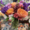 BI COLOR ROSES, MINI CARNATIONS, ALSTROMERIA, PURPLE STOCK AND GREENS IN A