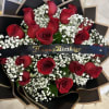 Bouquet of red roses with white baby's breath and a Happy Birthday ribbon