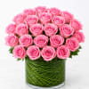 Pink roses arranged in a clear glass vase