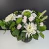 White and green floral arrangement in a glass vase