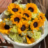 Bouquet of sunflowers and pale green carnations wrapped in white paper