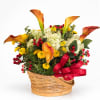 Basket arrangement with orange calla lilies, white hydrangeas, and yellow mums
